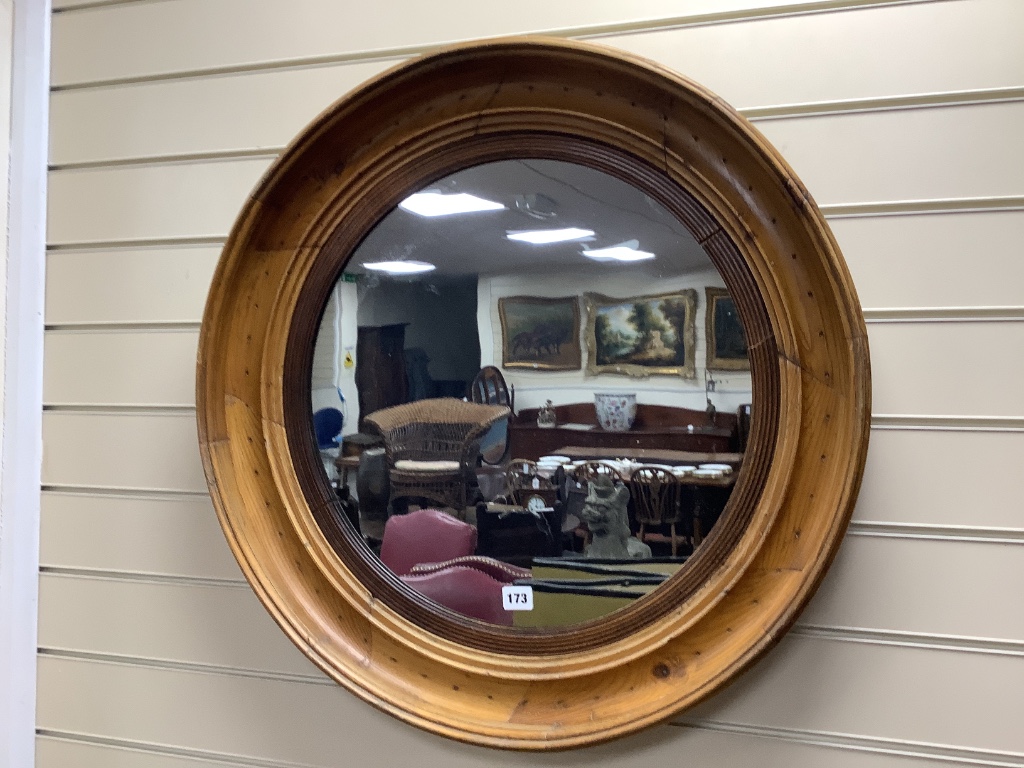 A 19th century circular pine framed mirror, diameter 68cm